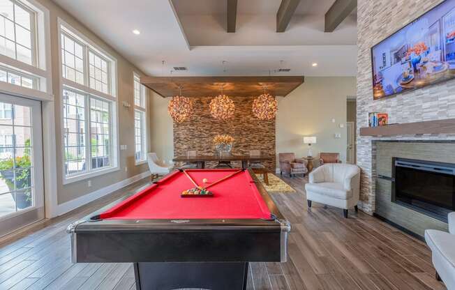 clubhouse interior with a pool table and fireplace