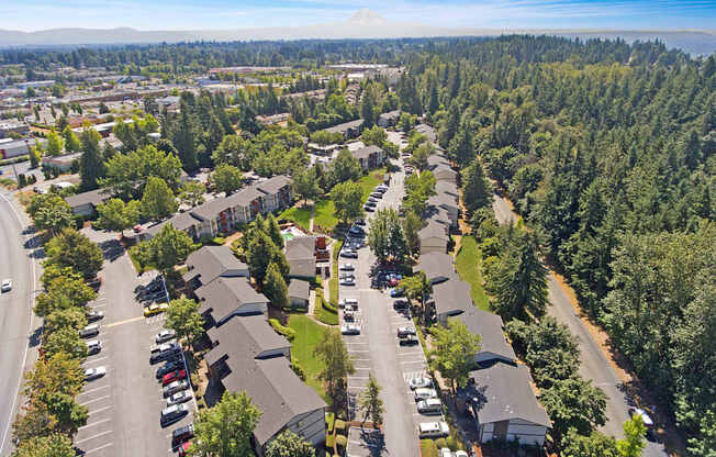 A bird's eye view of a residential area with houses and cars.