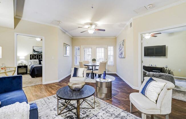 a living room with furniture and a ceiling fan