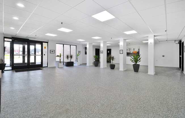 A spacious office with grey flooring and white walls.