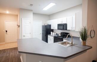 Kitchen with White Cabinetry and Black Appliancesat One Rocky Ridge Apartment, Georgia