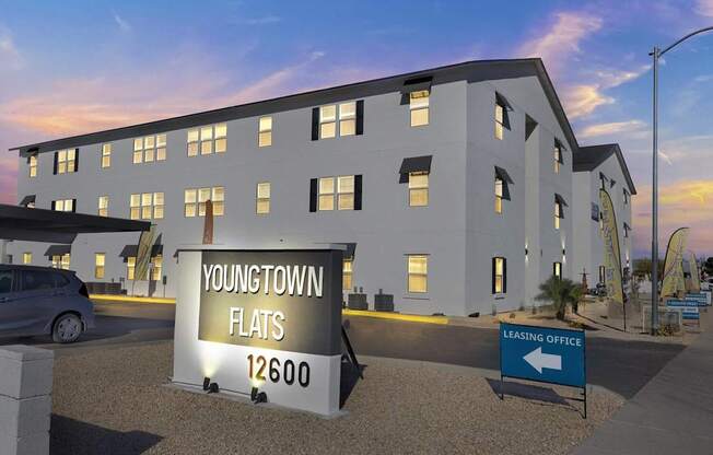 A sign for Youngtown Flats is shown in front of a building.