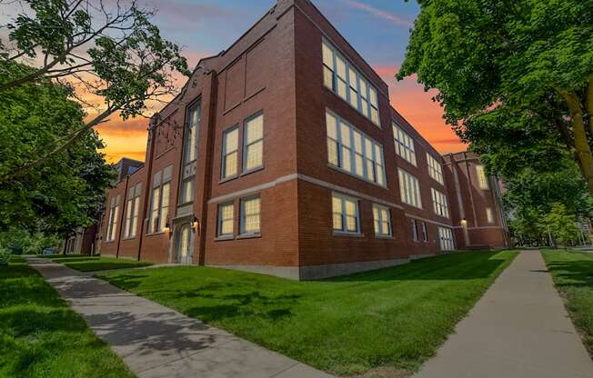 A red brick building with a walkway in front.