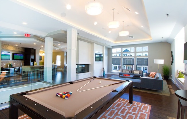 Game room with pool table, fireplace and flatscreen TVs