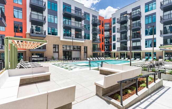 A fresh perspective on downtown leisure — unwind in the expansive pool courtyard, designed for comfort, connection, and a splash of sun.
