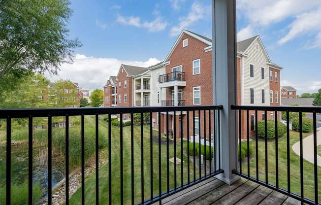 a balcony with a view of an apartment building