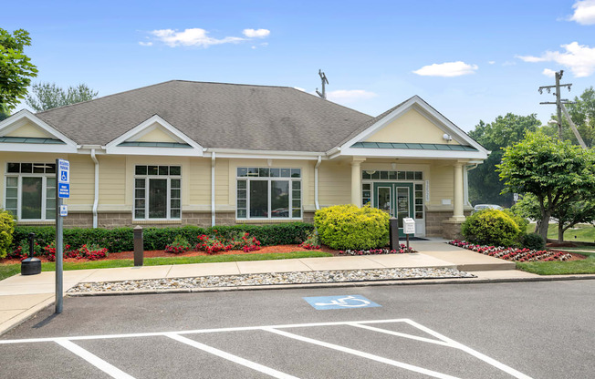 a house with a parking lot and a street sign in front of it