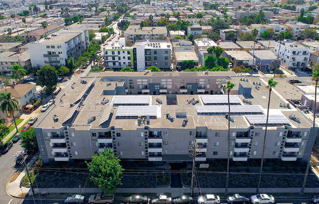 Over head drone shot of building with solar panels on roof.