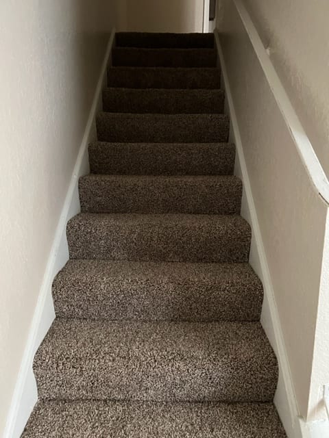 a long white shelf with a bunch of brown curtains on it