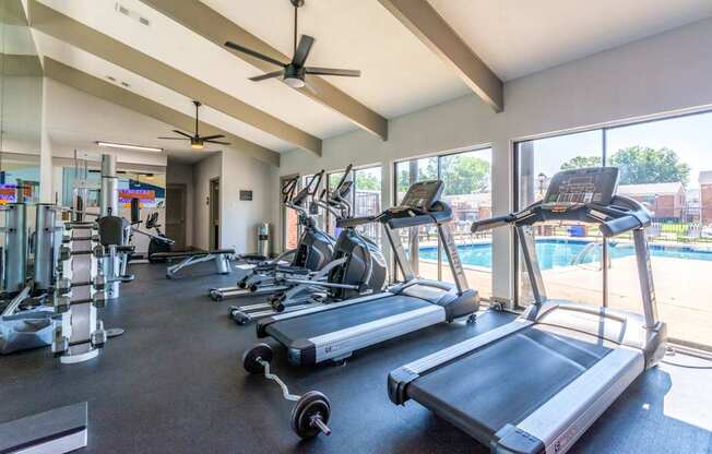 A gym with treadmills, elliptical machines, and other exercise equipment.