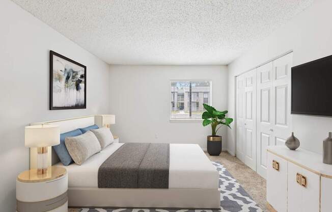 A bedroom with a bed, nightstand, and a plant.