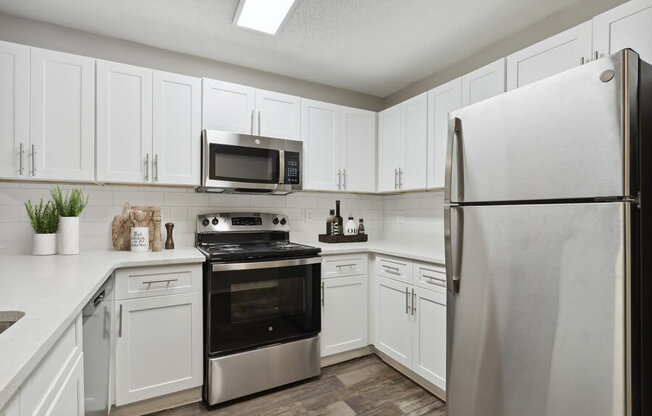 Model kitchen with stainless steel appliances at Retreat at Stonecrest Apartments