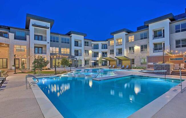 a large swimming pool in front of an apartment building at Hunters Creek Apartments, Texas