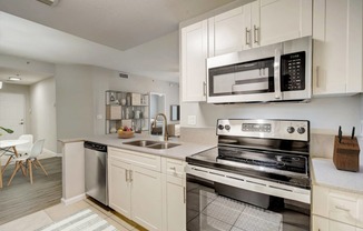 a kitchen with stainless steel appliances and white cabinets