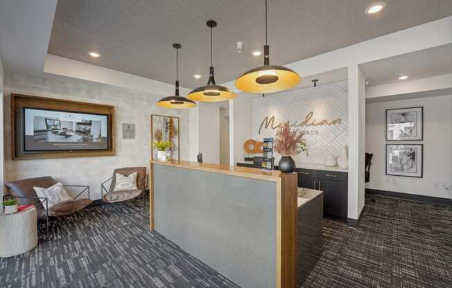 a lobby with a reception desk and a wall with a mural