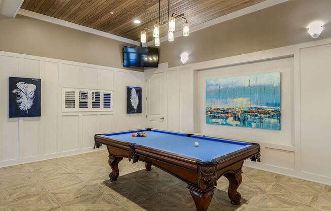 a game room with a pool table and a television  at Palm Bay Club, Jacksonville
