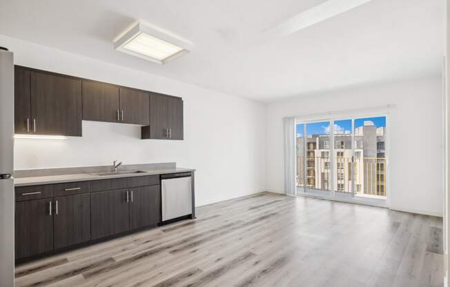 open-concept floorplan with custom cabinets and stainless steel appliances in the kitchen at One Santa Fe luxury apartments