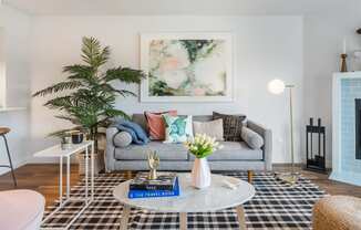 a living room with a gray couch and a coffee table