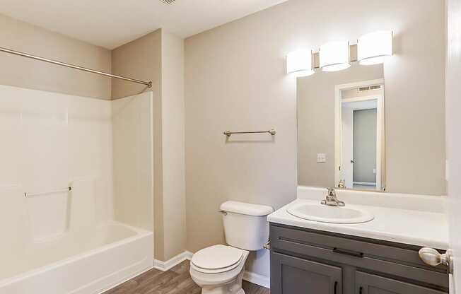 A white toilet sits next to a sink in a bathroom.