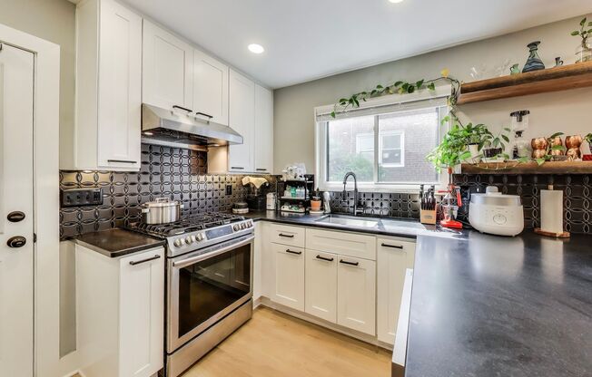 Welcome to this fully renovated, contemporary row home nestled in Michigan Park!