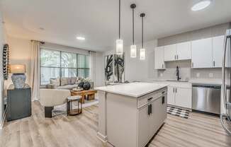 A modern kitchen with a dining table and chairs.