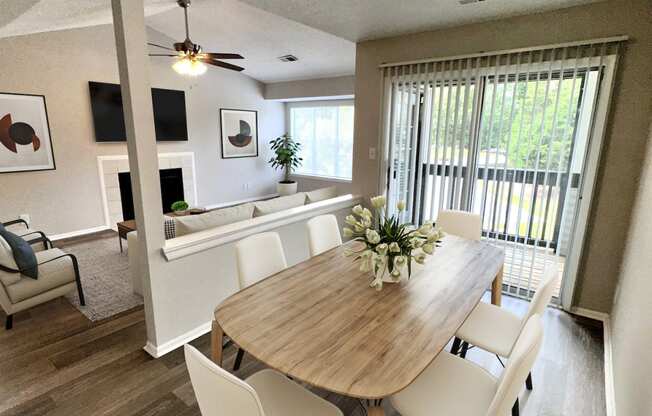 a dining room and living room with a table and chairs