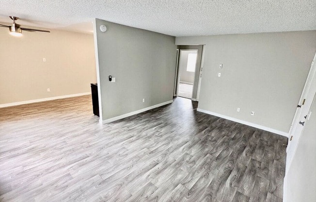 an empty living room with a hard wood floor at The Arches Apartments, LLC, El Cajon, CA 92021