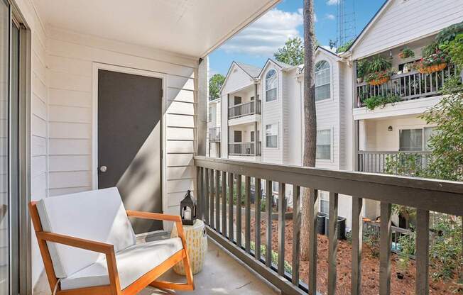 A balcony with a chair and table.