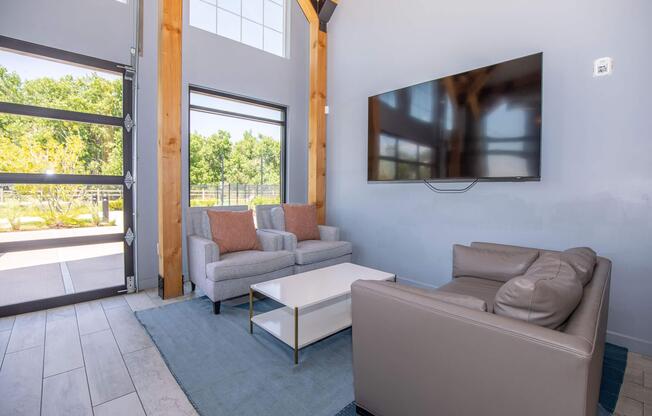 a living room filled with furniture and a large window