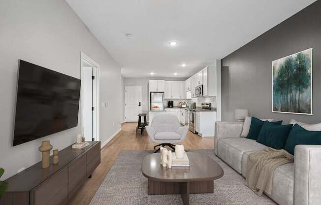 A modern living room with a grey couch and a coffee table.