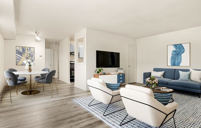 A living room with a white table and blue couch.