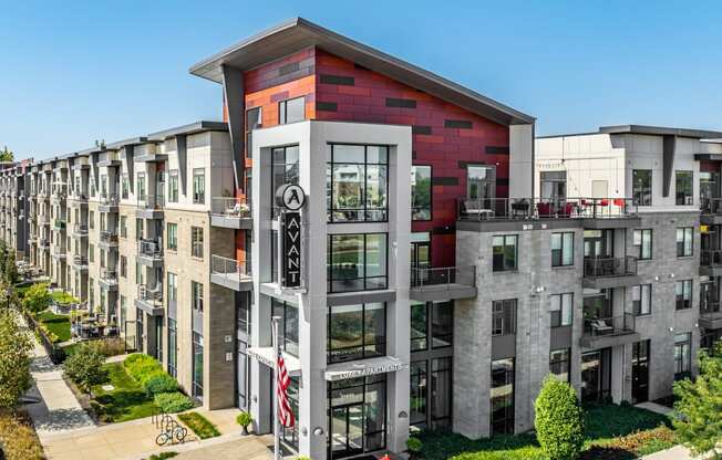 an aerial view of a large apartment building with red and white facade