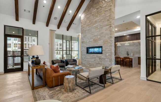 a large living room with a stone fireplace and a tv