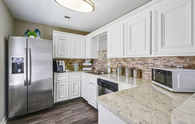 Clubhouse kitchen with white cabinets and stainless steel appliances
