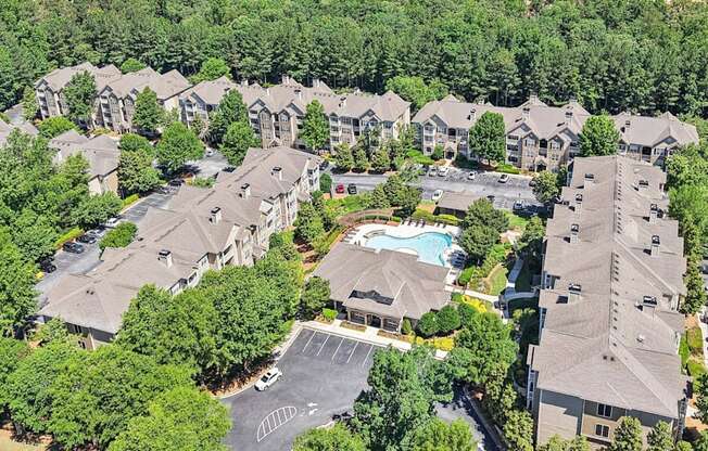 A bird's eye view of a residential complex with a swimming pool.