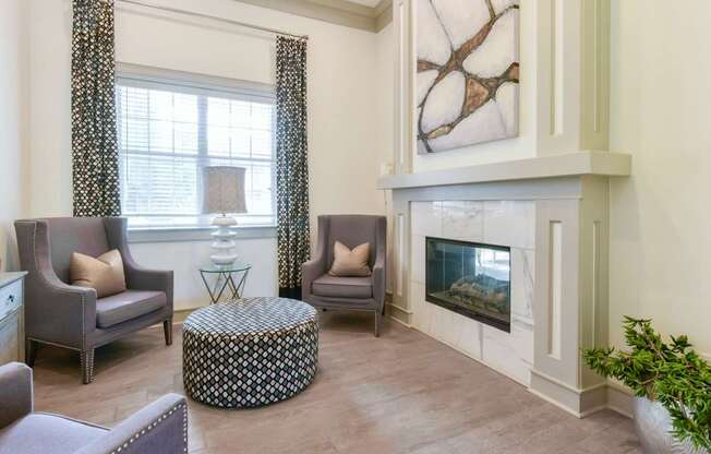 A living room with a fireplace and a painting on the wall.