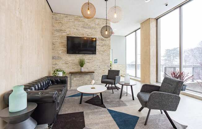 a living room with couches and chairs and a television