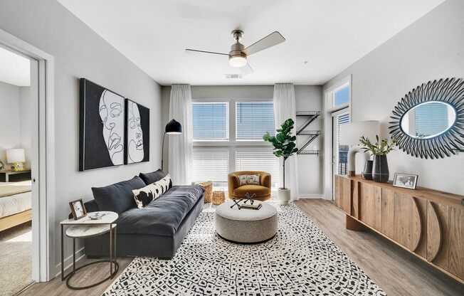 a living room with a couch and a ceiling fan