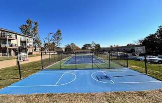 a tennis court with a fence around it on a blue court