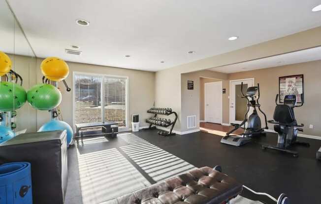A spacious home gym with a variety of exercise equipment.