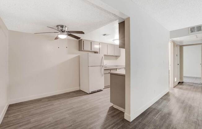 A room with a ceiling fan and a cabinet.