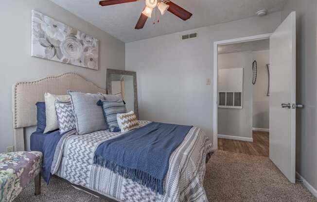 a bedroom with a bed and a ceiling fan