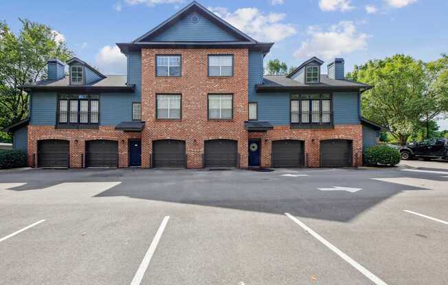 A large two-story building with a parking lot in front.