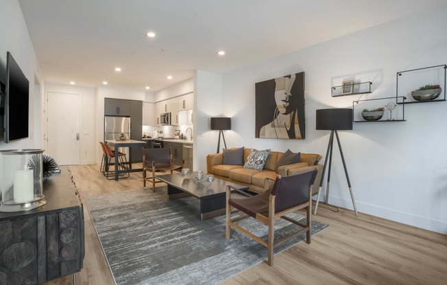 a living room with a couch and chairs and a table