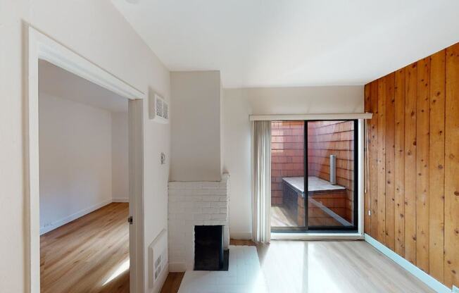 a bedroom with a medium sized window and a door that leads to a balcony