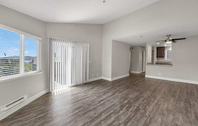 the living room of an empty house with a large window