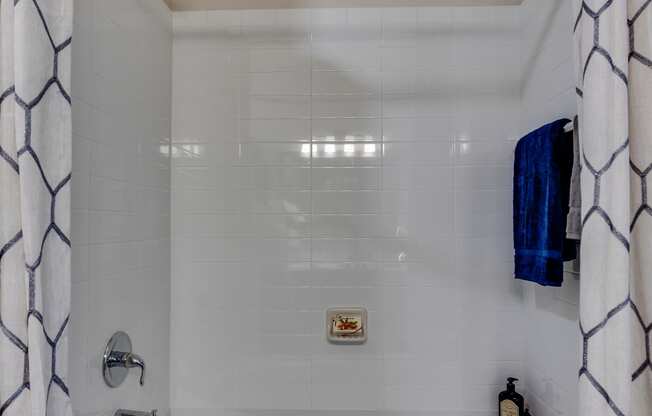 a small bathroom with a tub and a shower curtain