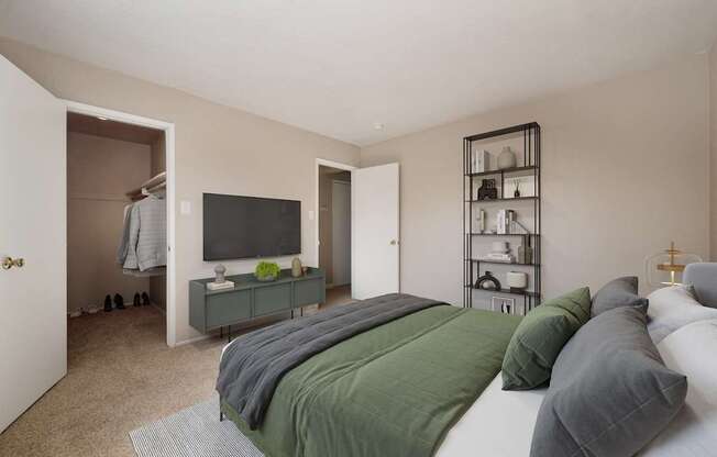 A bedroom with a bed, a television, and a shelf with various items.