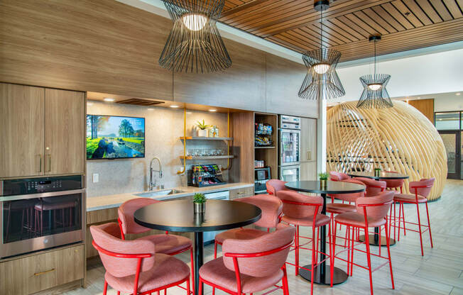 a dining area with chairs and tables and a kitchen