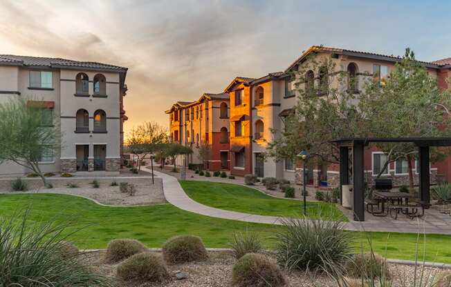 a group of houses in a row with a sunset in the background